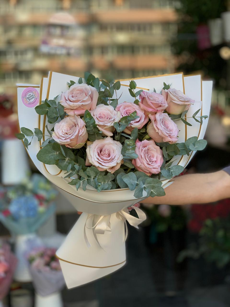 Buchet 9 trandafiri roz pudrat cu eucalipt verde, ambalaj crem elegant cu panglică, The Bloom Room București